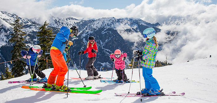 Family skiing together on a sunny Bansko slope